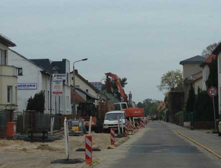 Foto: auf der Straßenbaustelle wird vor dem Grundstück 168 gebaggert