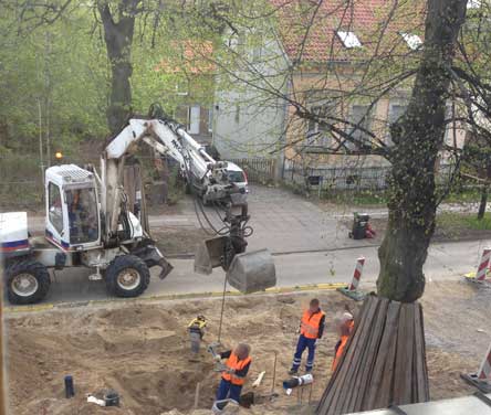 Foto: auf der Straßenbaustelle wird vor dem Grundstück wird mit dem Bagger gebaut