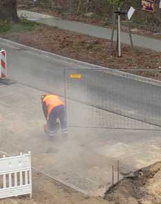 Foto: auf der Straßenbaustelle wird am Beginn der Straße ein Stück Beton herausgeschnitten